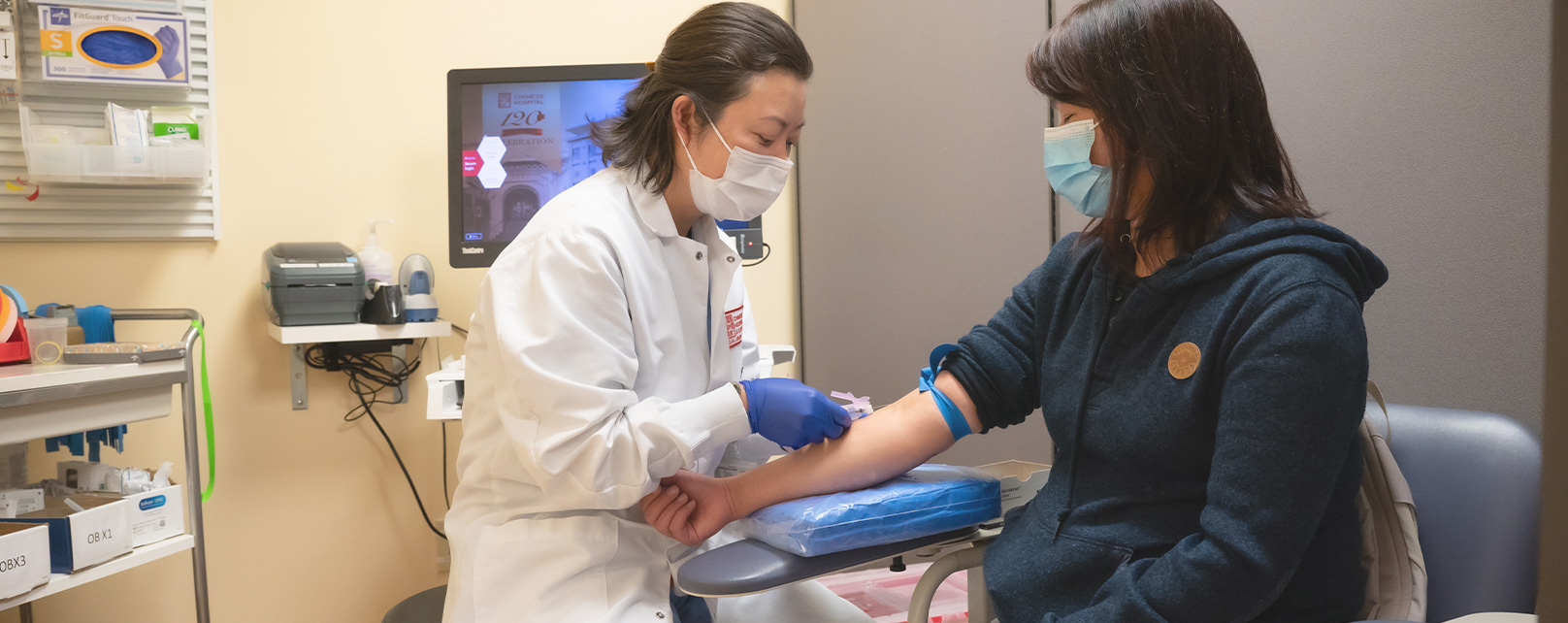 a phlebotomist is doing blood draw for a patient