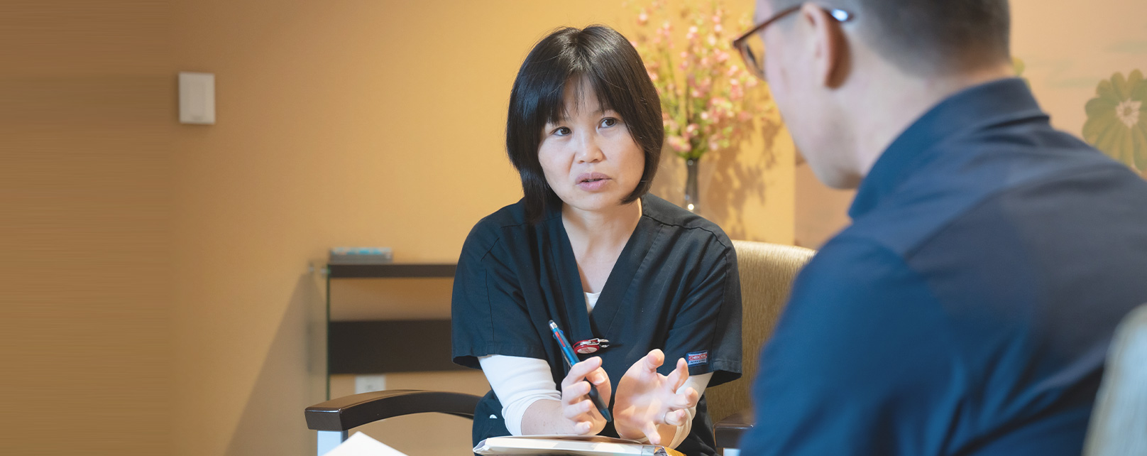 A medical professional talking to a patient