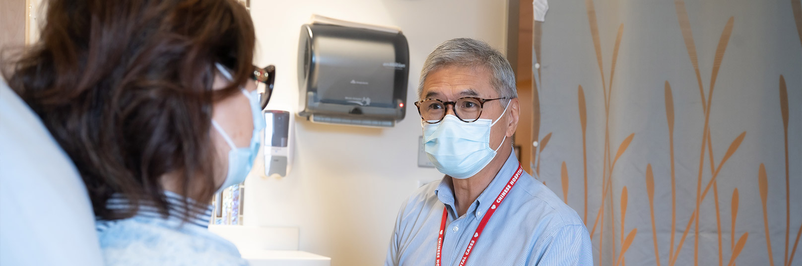 a male healthcare worker is looking at a female patient
