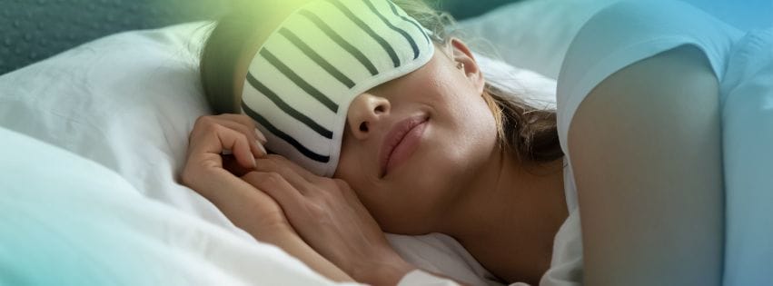 a woman sleeping with a sleeping mask