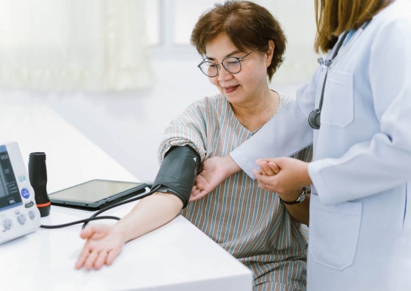 Patient receiving blood pressure check.