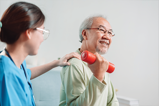 Elderly patient exercising with weights.